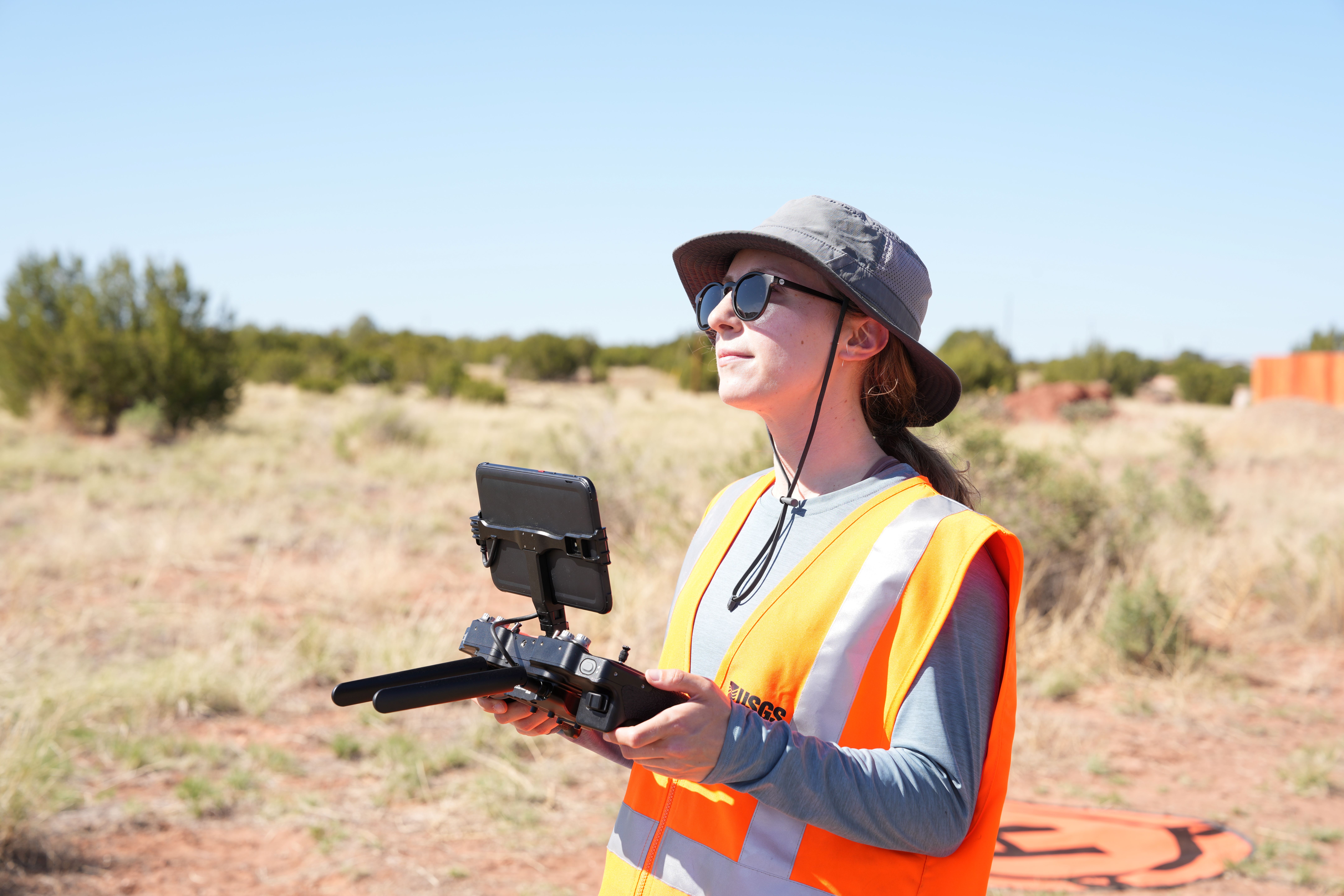 Professional remote pilot operating a mapping drone during field data collection