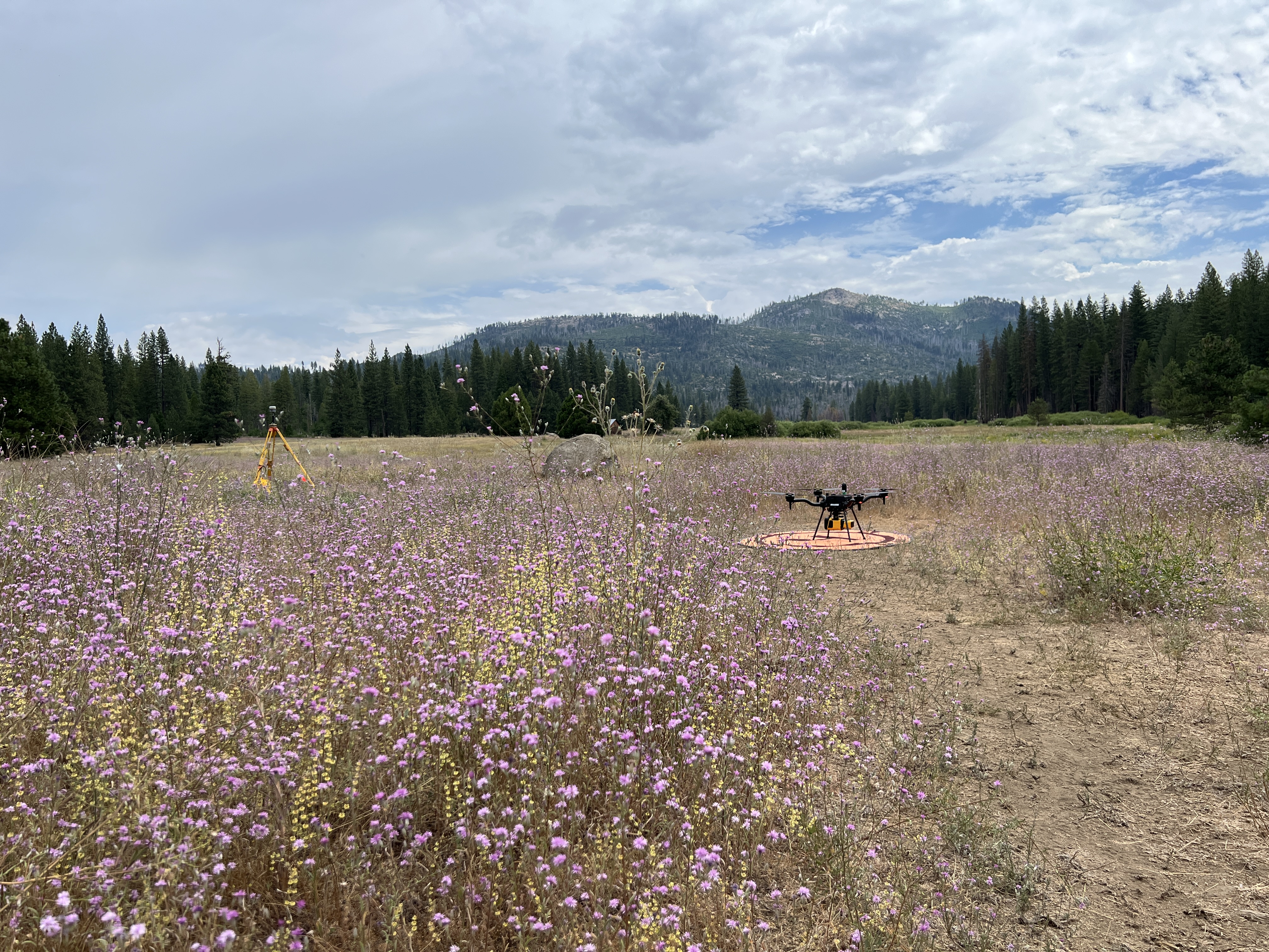 Survey drone and ground control equipment positioned in a large open landscape