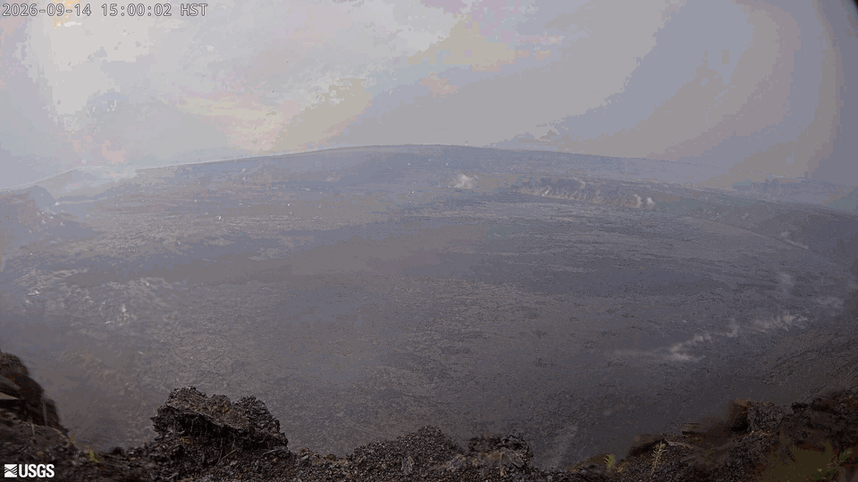 Animated gif consisting of color webcam images showing a lava flow in the distance at night