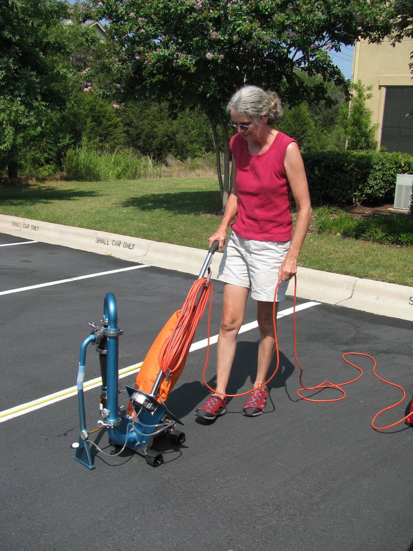 Image: Collecting parking lot sealant samples