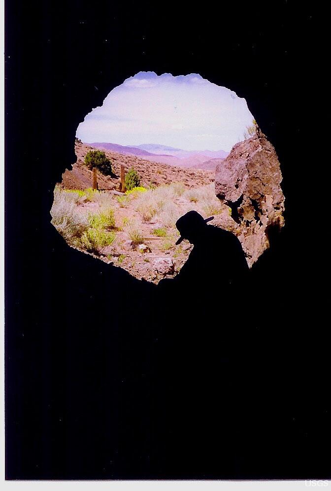 Image: Silhouette in Cave With Mountains in Horizon