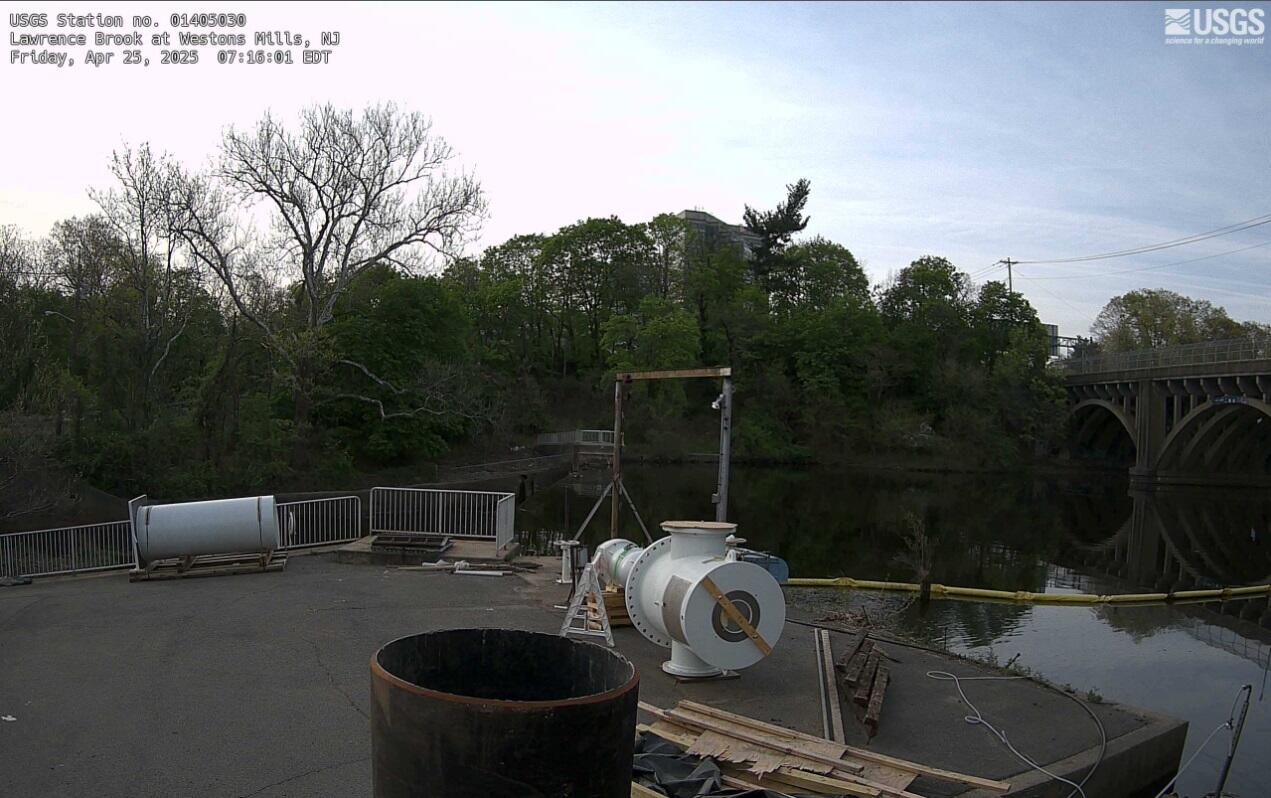 Looking across a cluttered industrial landing towards the river beyond