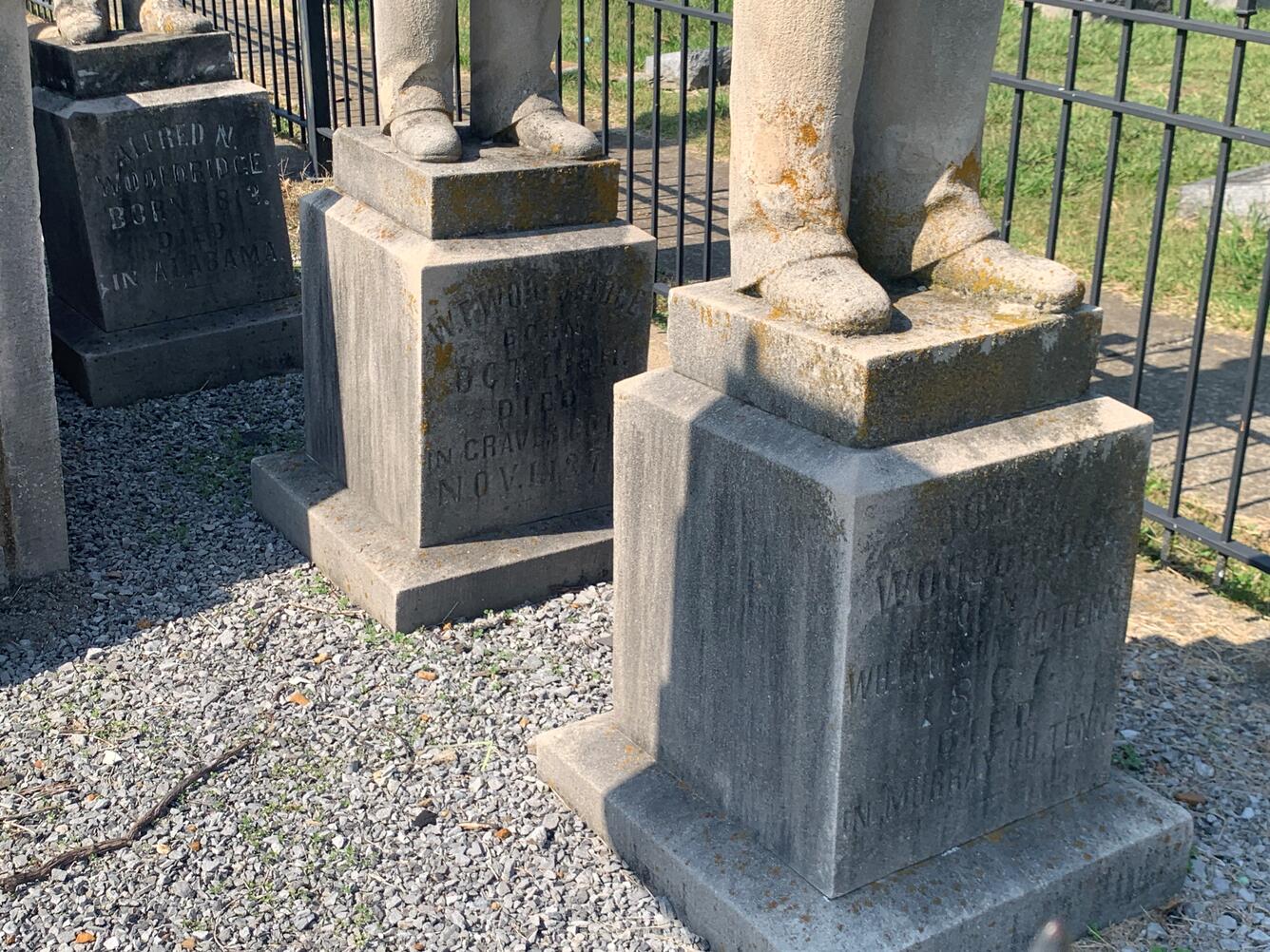 A group of weathered statue pedestals with inscription