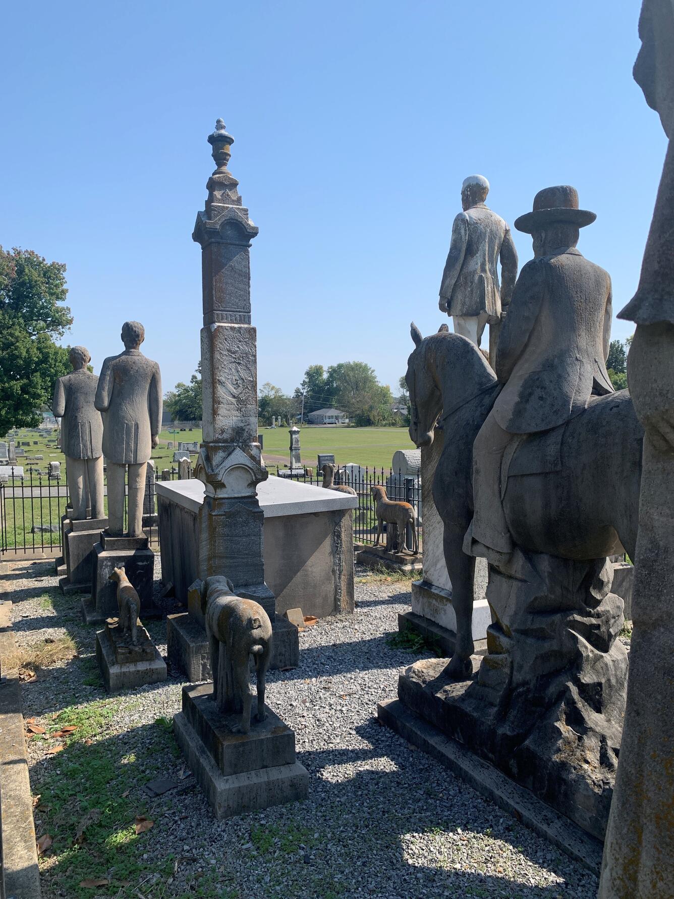 The vault of Colonel Henry Woolridge is surrounded by several weathered sandstone animal and human figures.