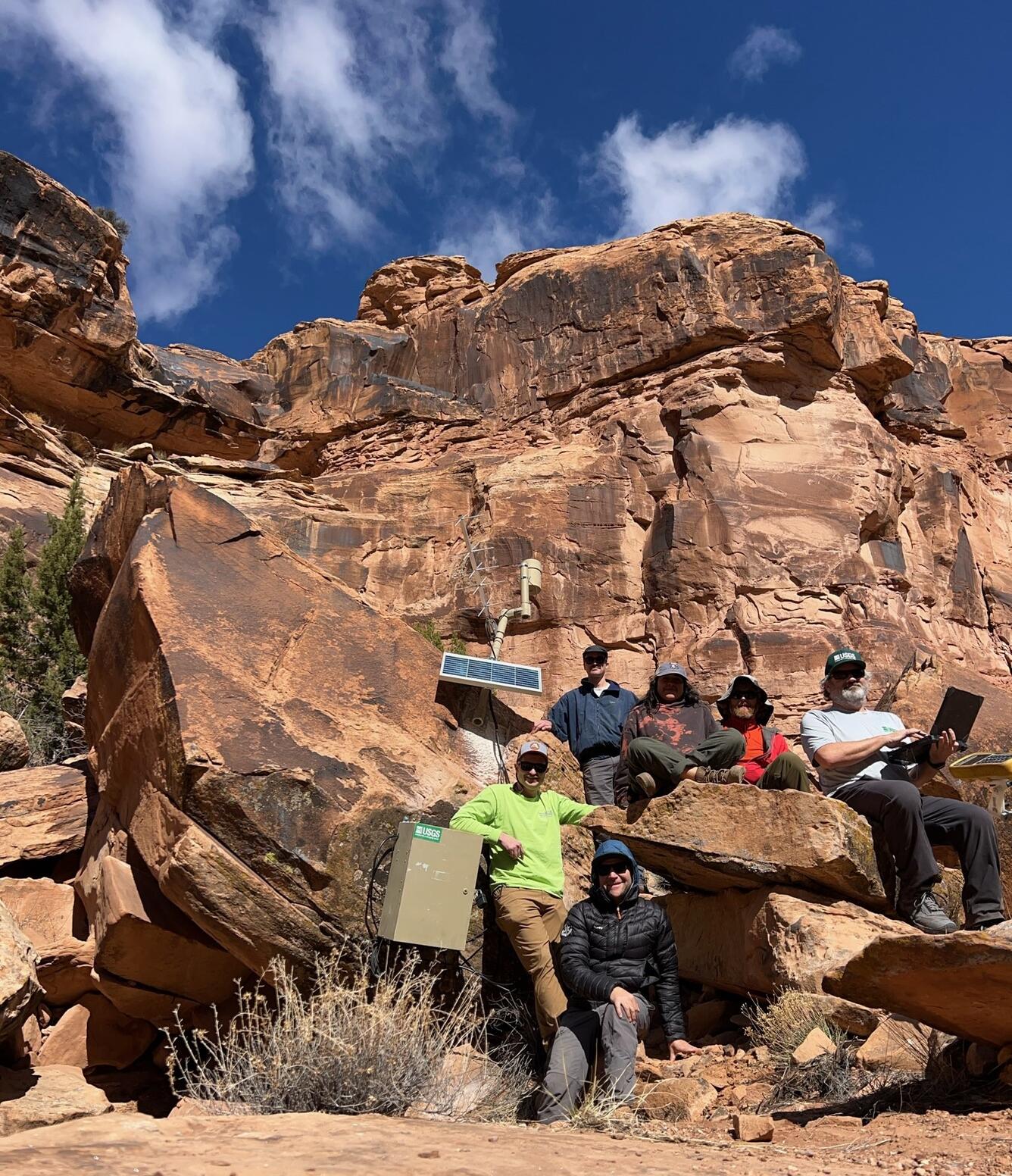 Six-member USGS field crew team up to install gage to rocks near Moab, Utah.