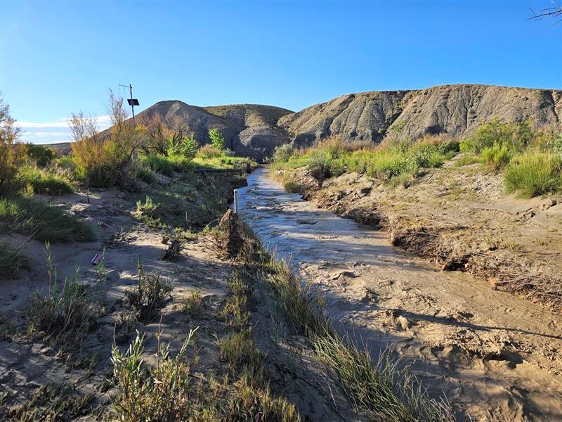 Small arid stream roils after heavy rains.