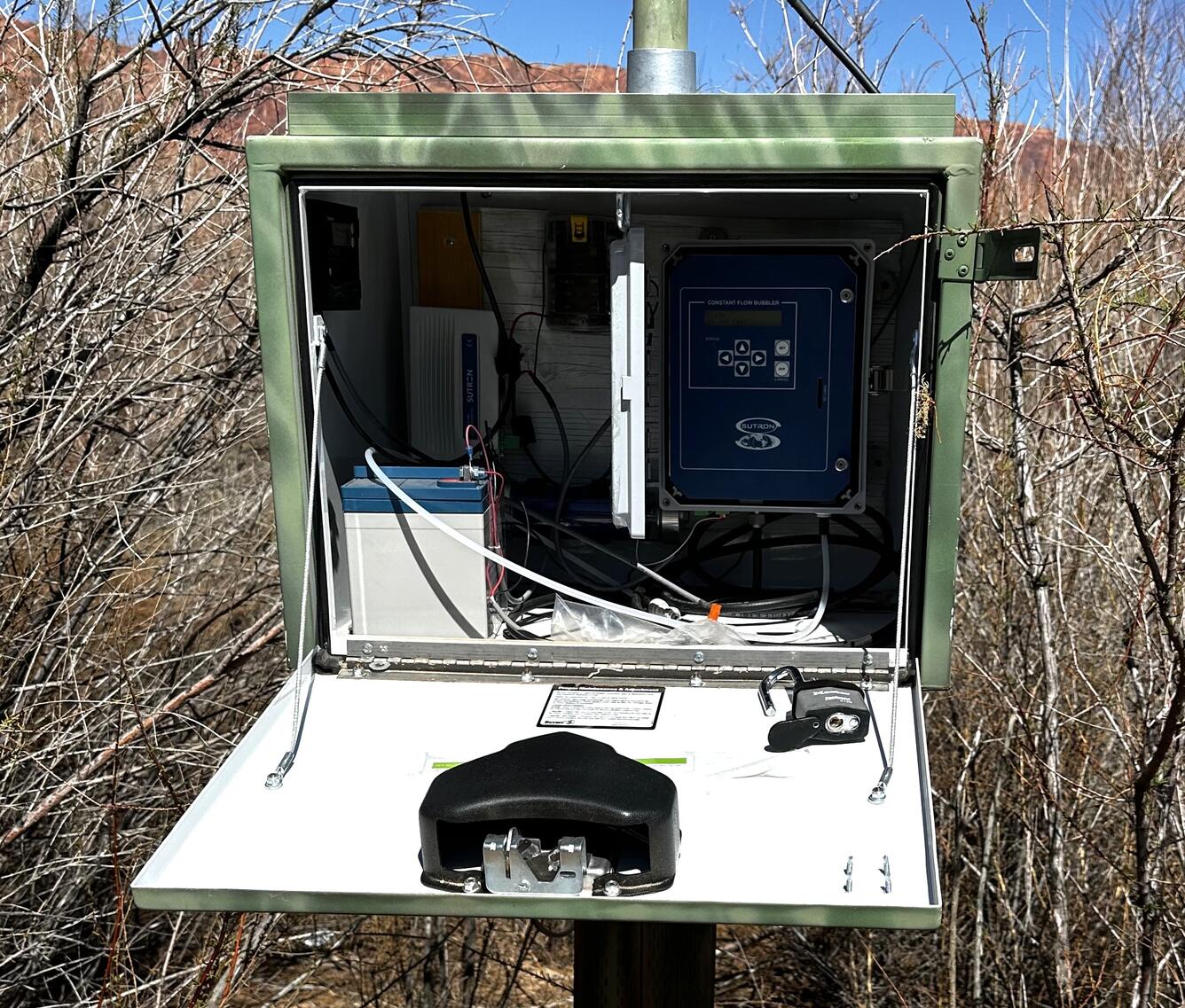 Open enclosure with stream gaging instrumentation visible.