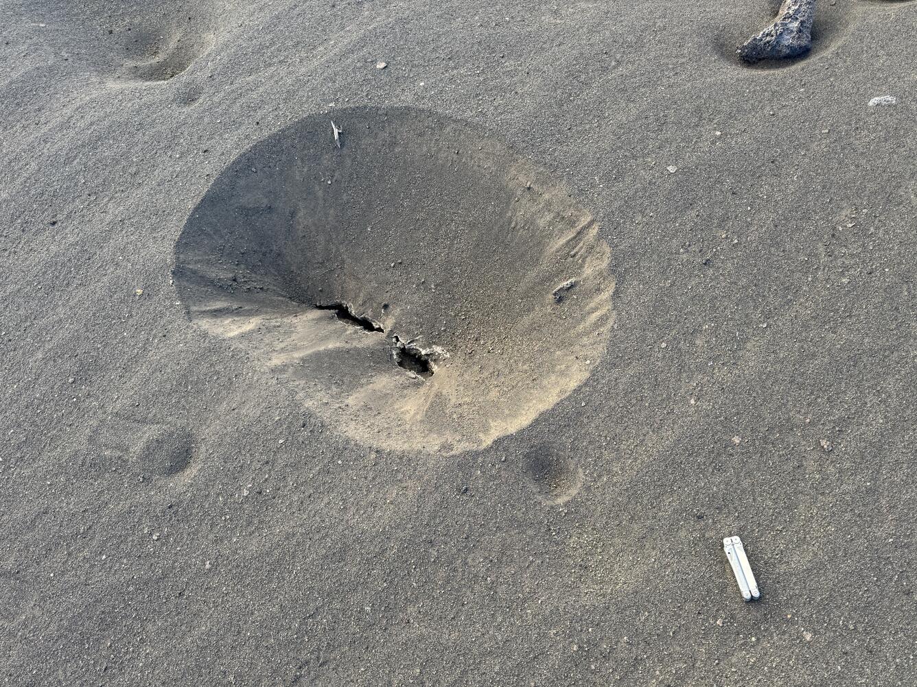 Color photograph of sinkhole deposit in a volcanic landscape