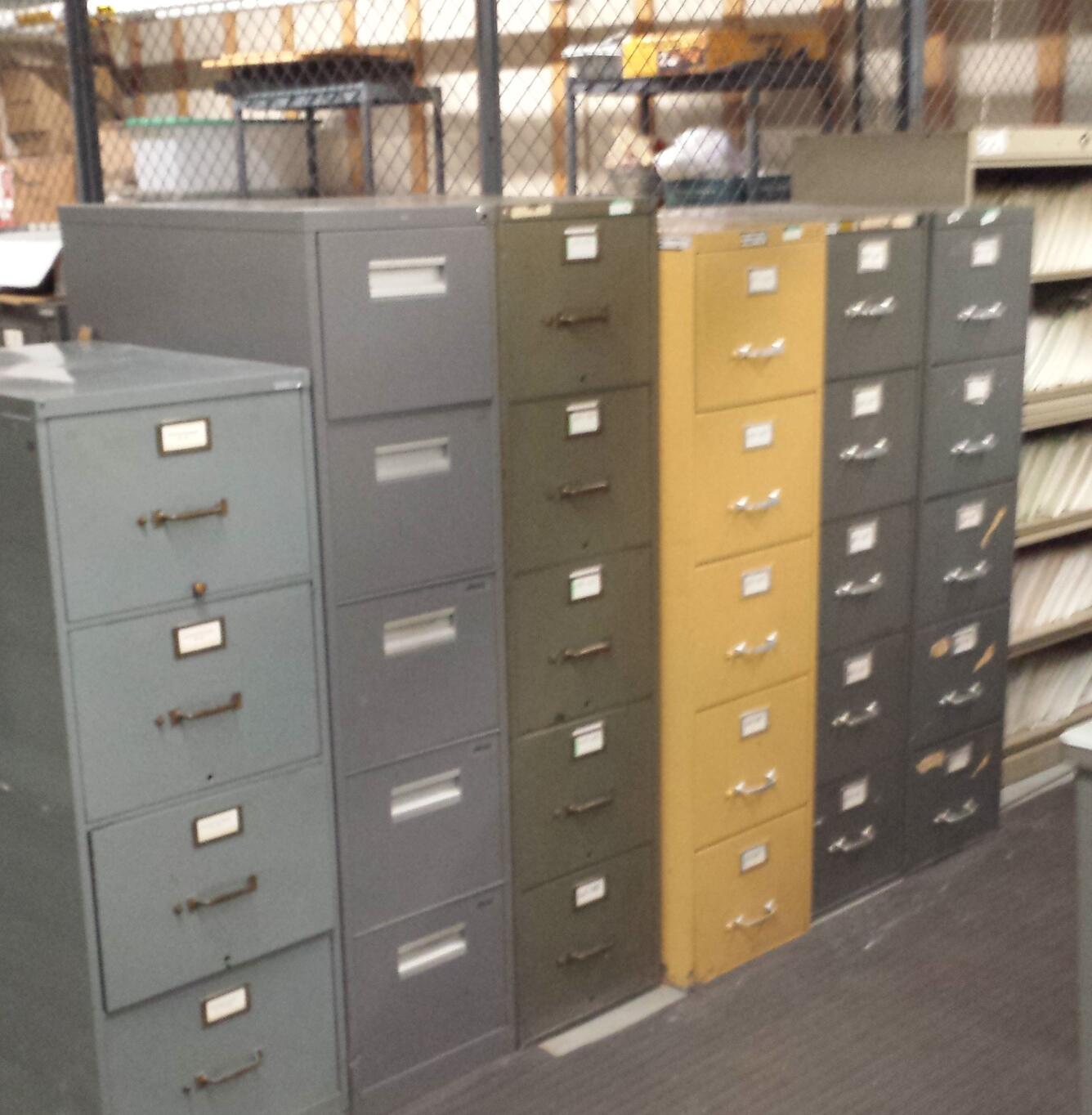 several file cabinets in a row of varying shades of blue, gray, and yellow