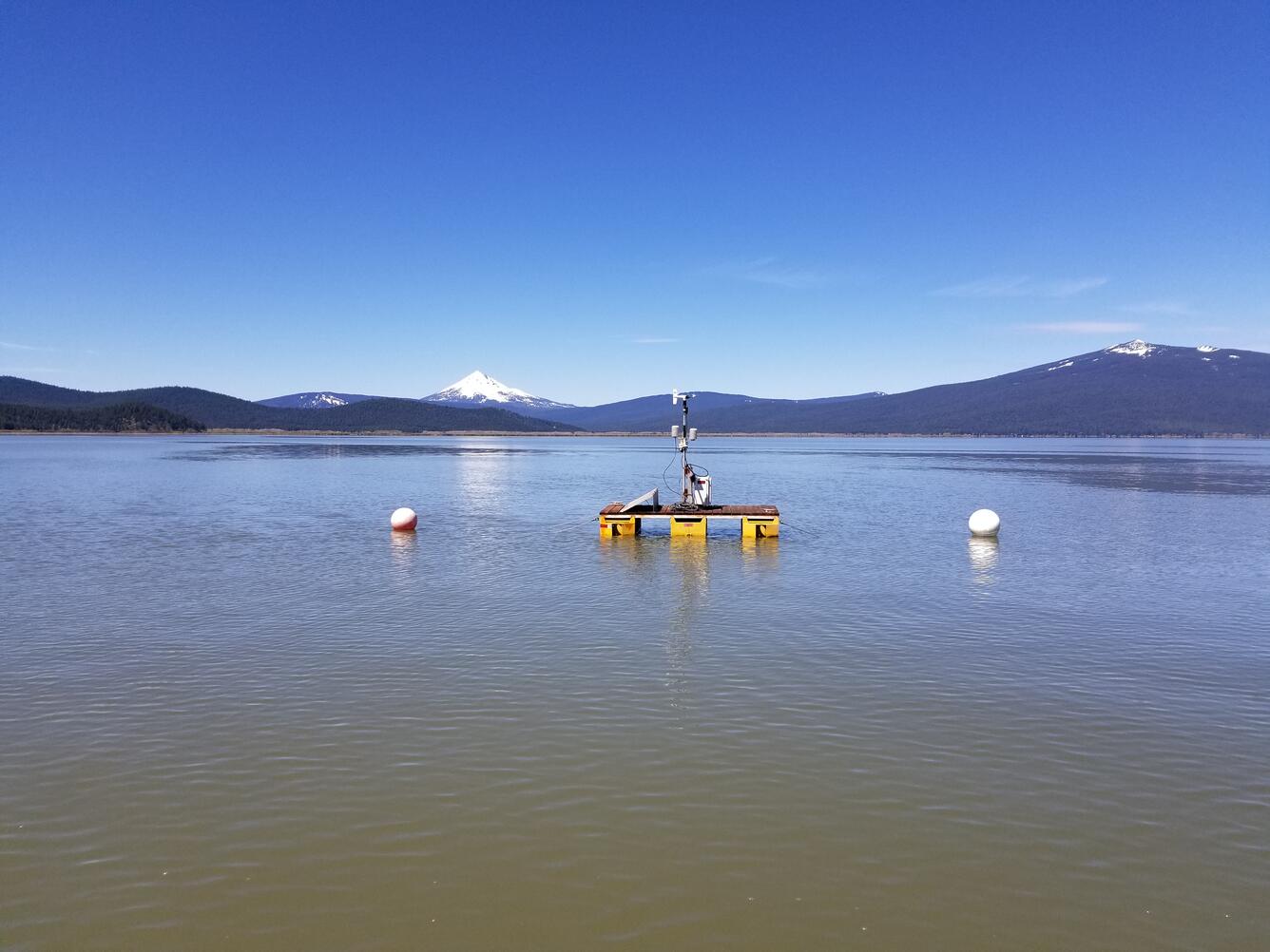 floating platform on upper Klamath Lake. Blue sky over lake water with distant snow capped mountain