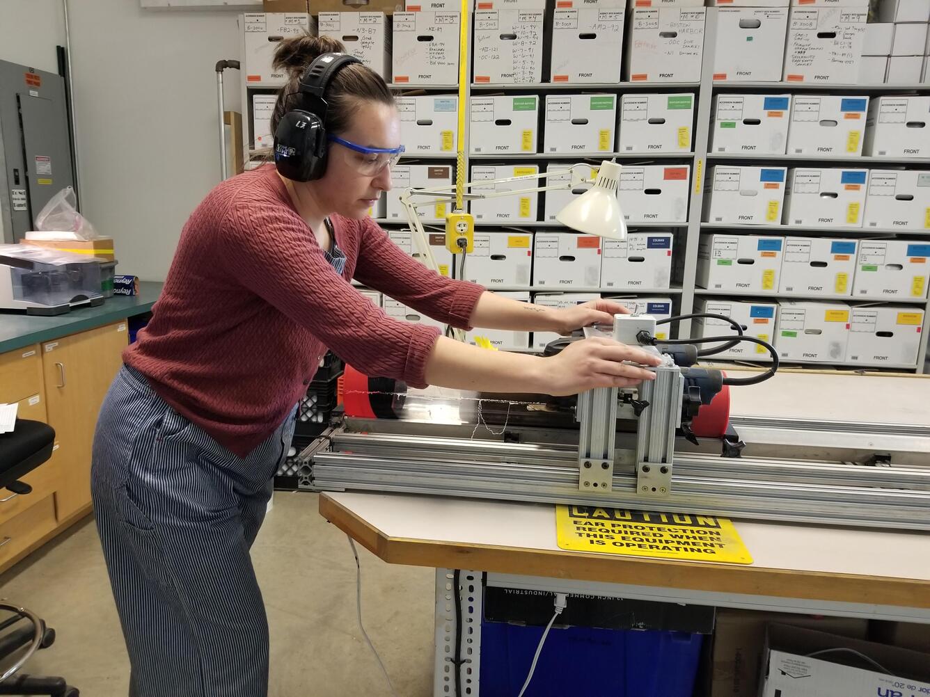 Person cutting a core sample with a core splitter