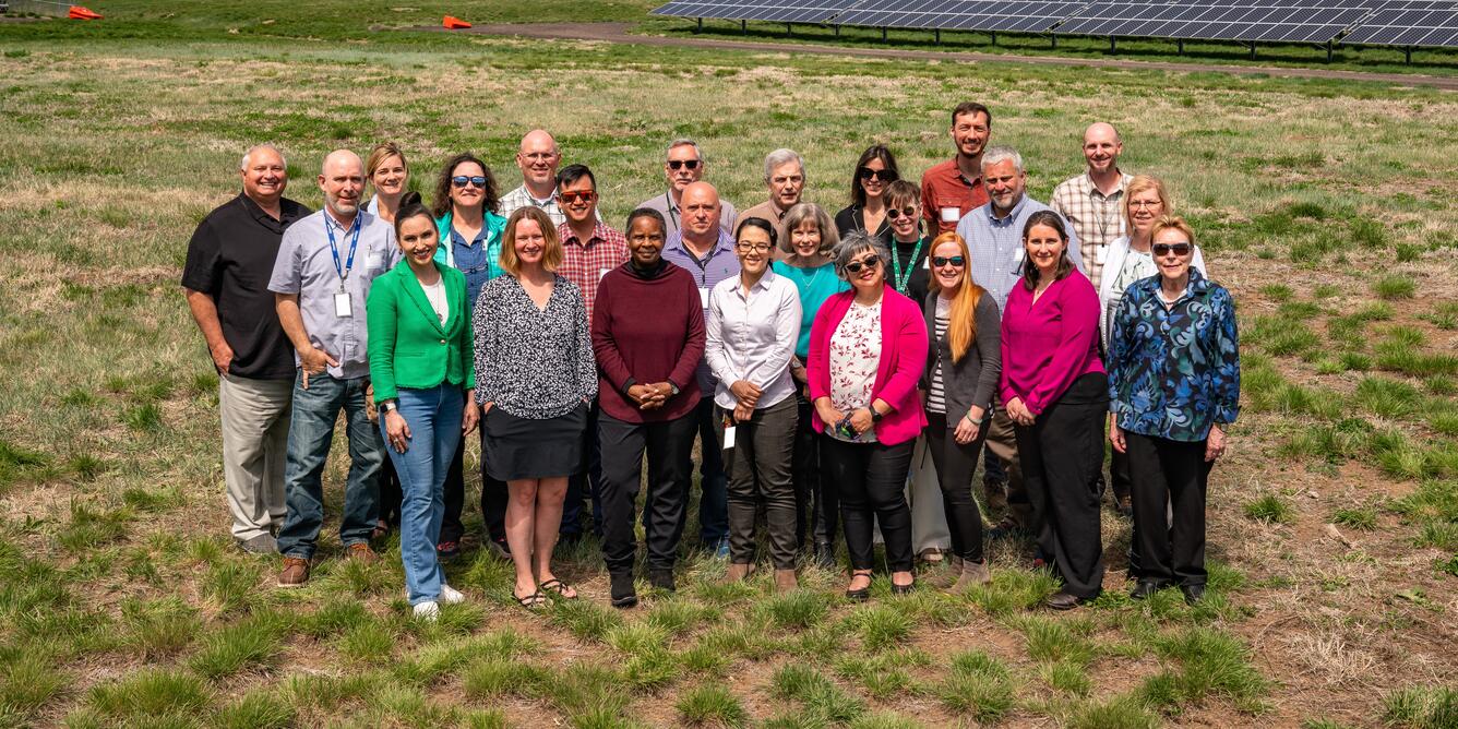 Photograph of NGP User Engagement staff members standing in a grass field