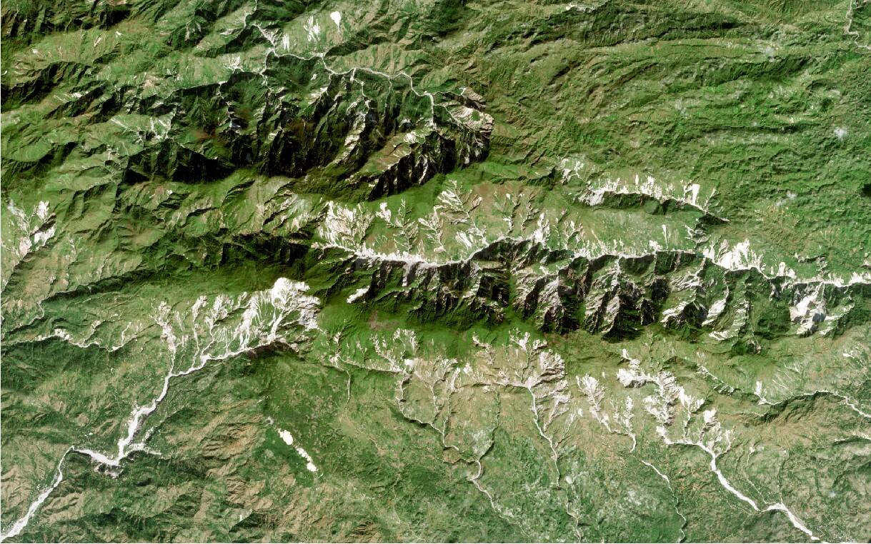 Areal view of rugged landscape with landslides visible on hillslopes