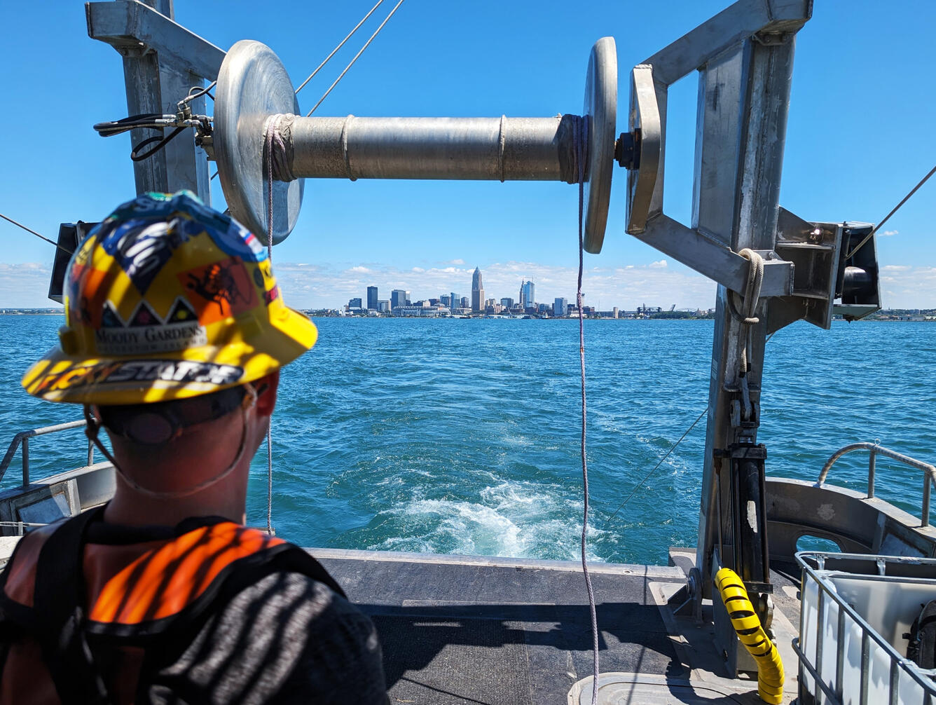 A researcher looks back at Cleveland as the vessel finishes deploying a new trawl net.