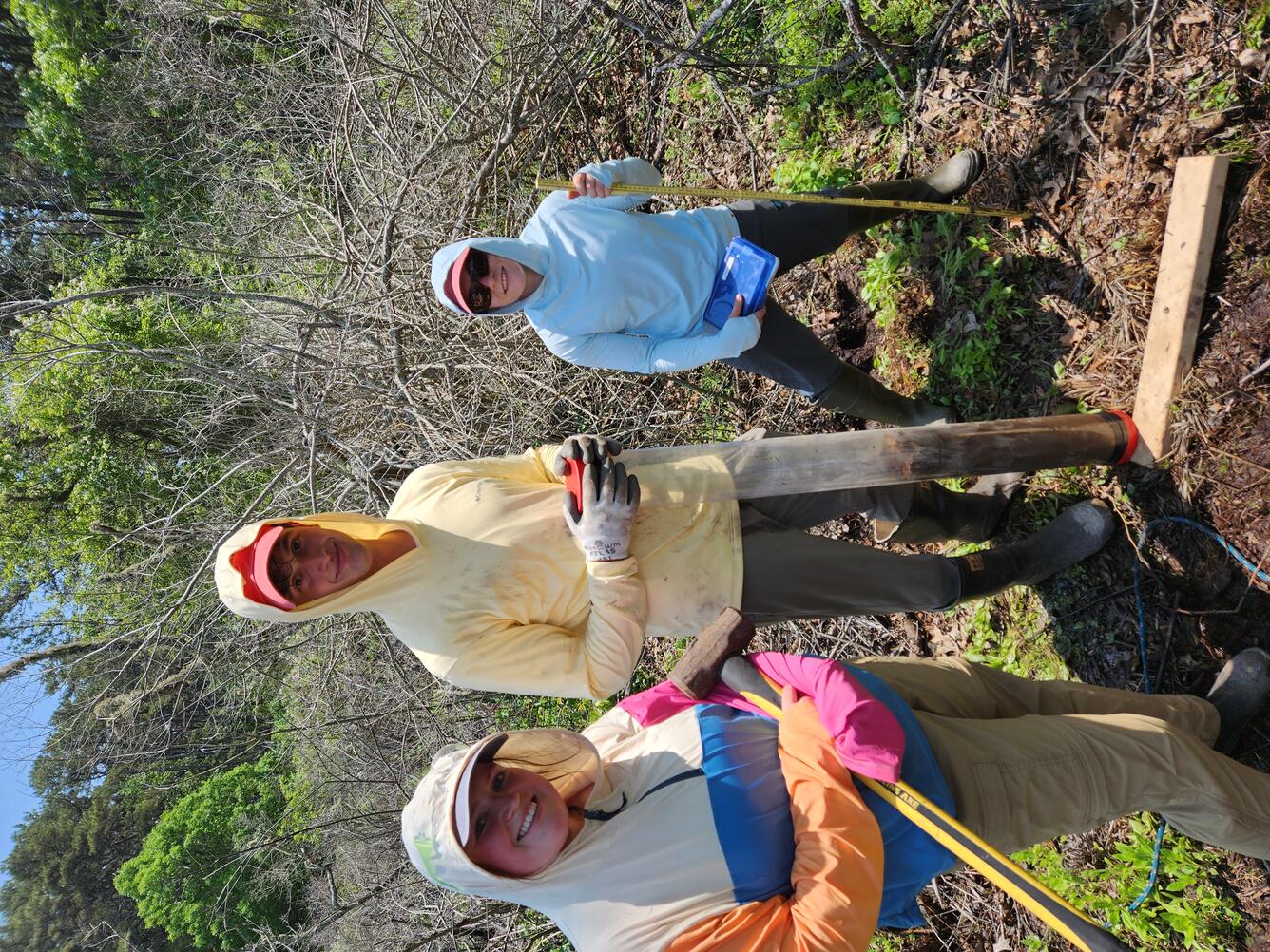 Interns smiling for a picture in a coastal wetland