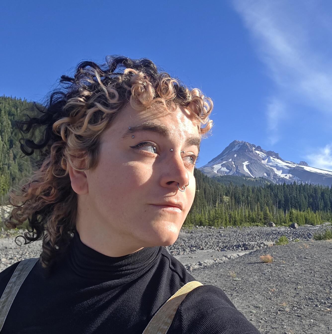 Woman with hat and flowing hair and life vest in profile picture