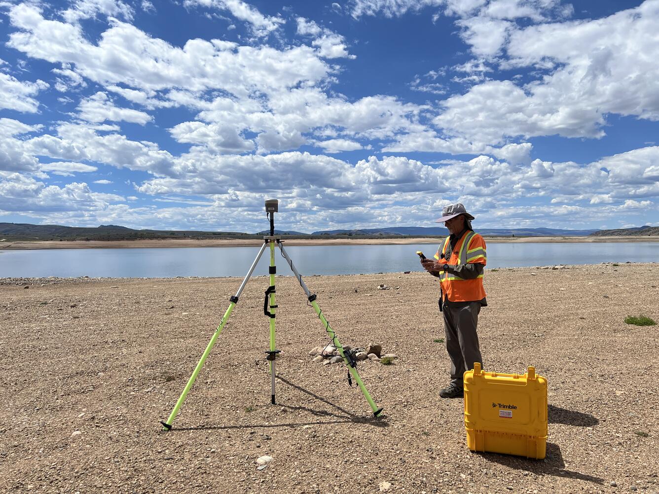 USGS remote pilot setting up instruments near the shore of Williams Fork Reservoir