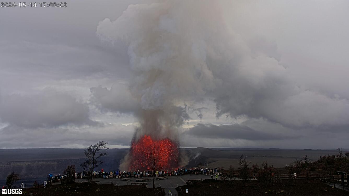 Color webcam image showing visitors at a National Park overlook viewing a lava fountain 