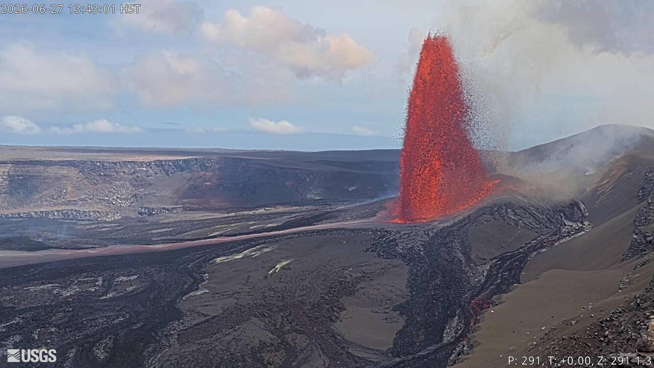 Color photograph of lava fountain erupting within crater