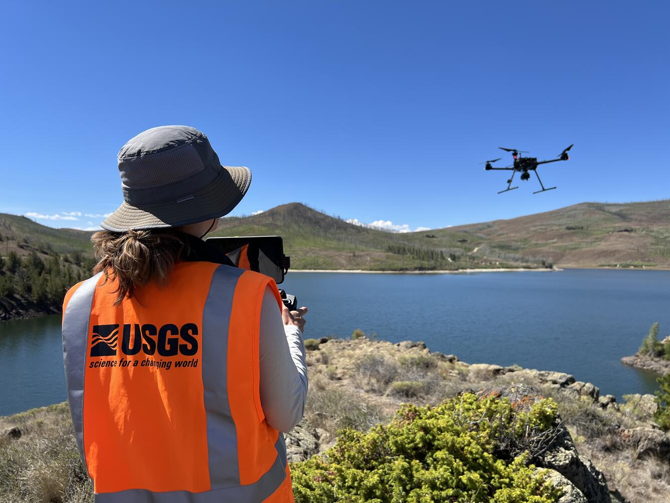 USGS drone pilot flies craft over reservoir