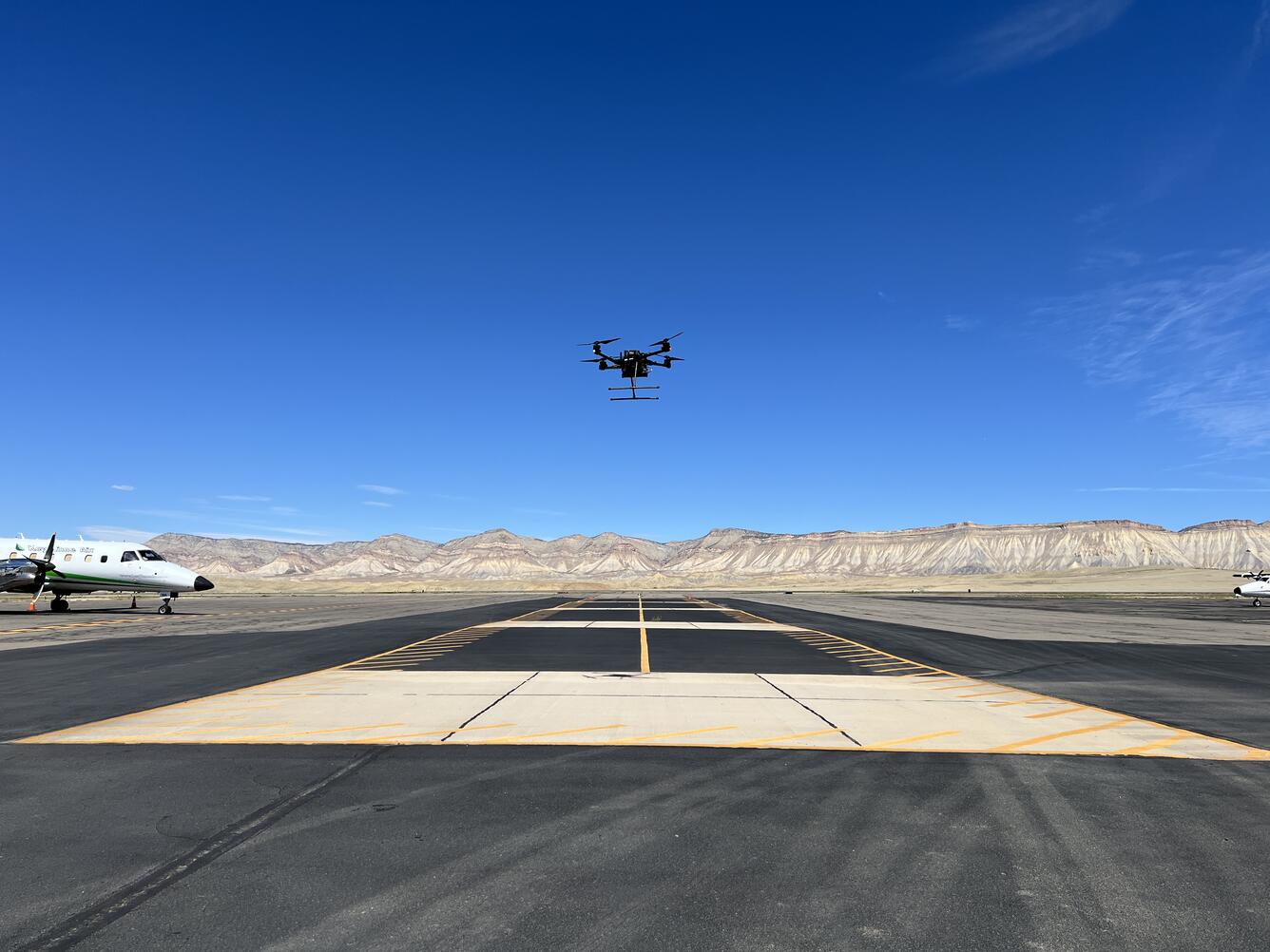 Drone hovering above airstrip at Grand Junction Regional Airport.