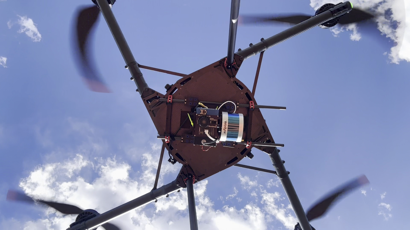Underside view of flying drone with hyperspectral imaging payload with integrated lidar sensor