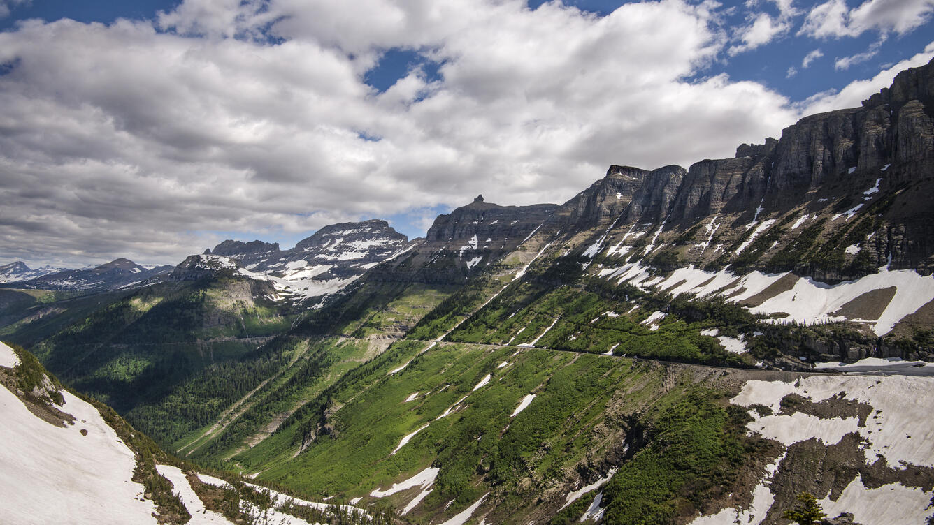 A road winds through rugged mountains
