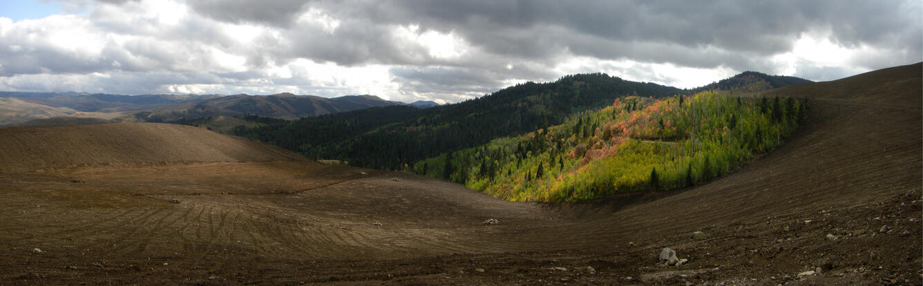 Photo of a large mine with hills in the background