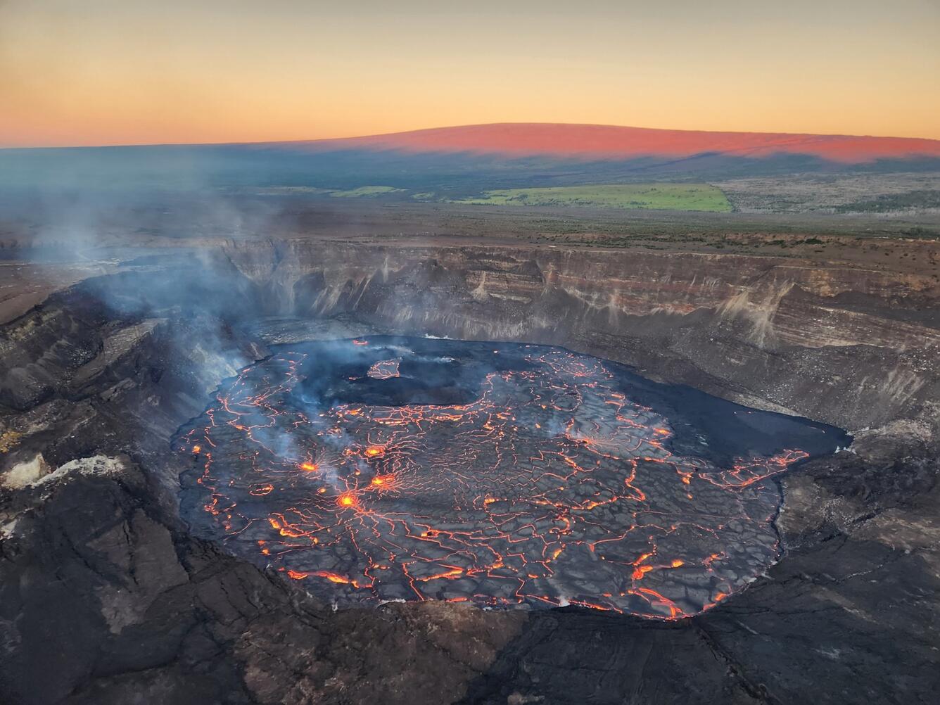 sunrise image of Kilauea caldera with lava