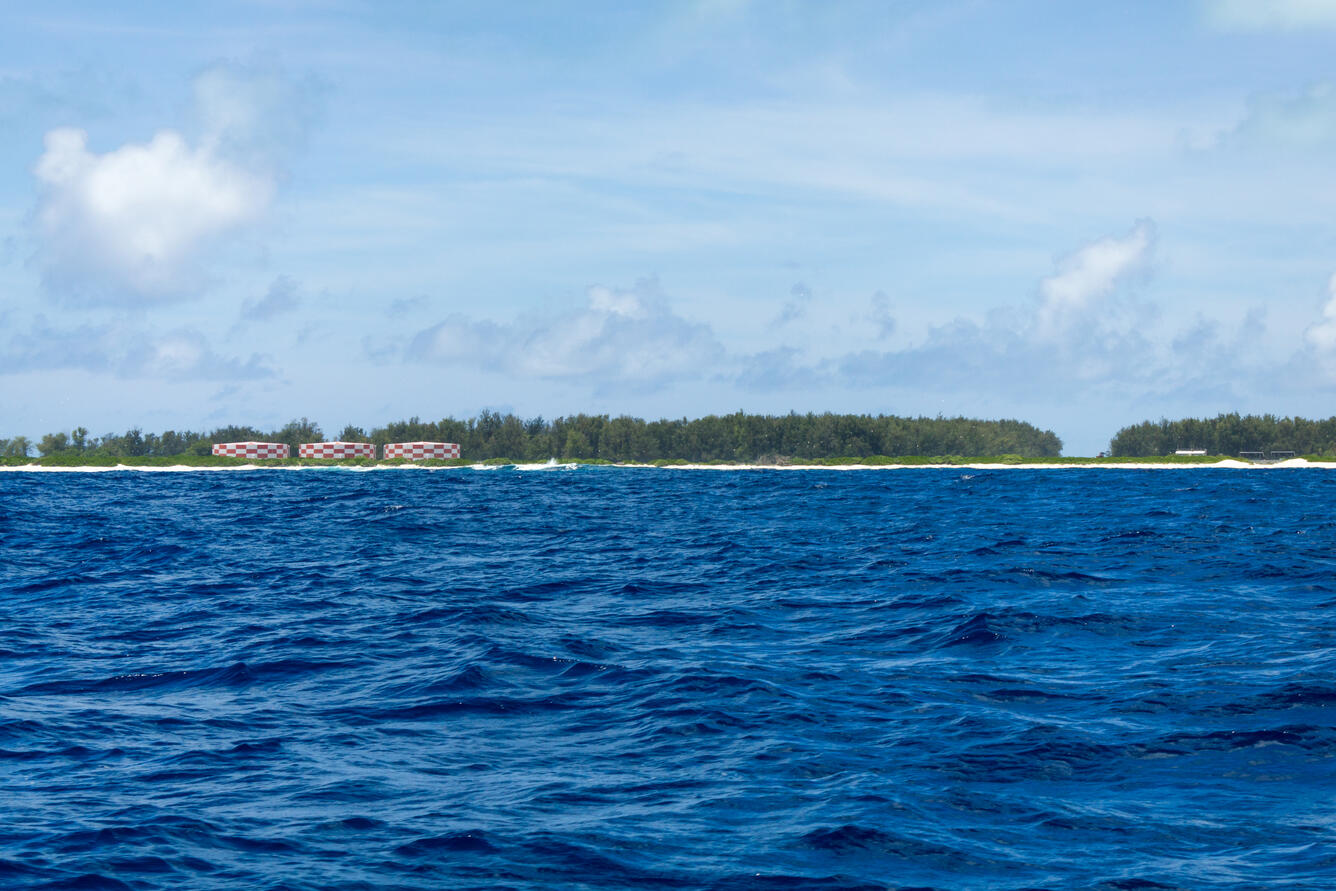Blue ocean looking towards tree-covered island