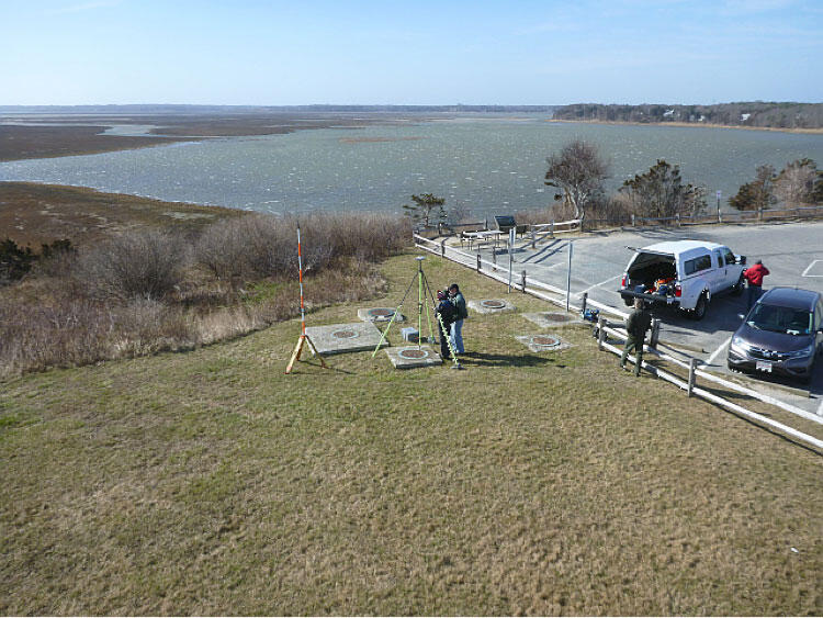 Image shows overhead view of a field work team setting up a UAS target to be used as a ground control point.