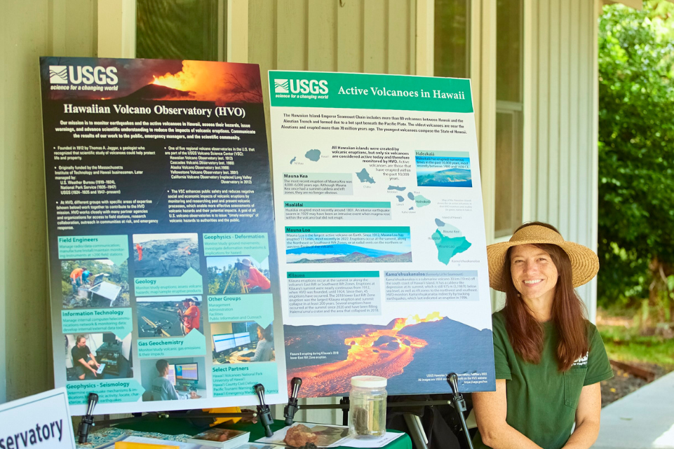Color photograph of scientist at information table