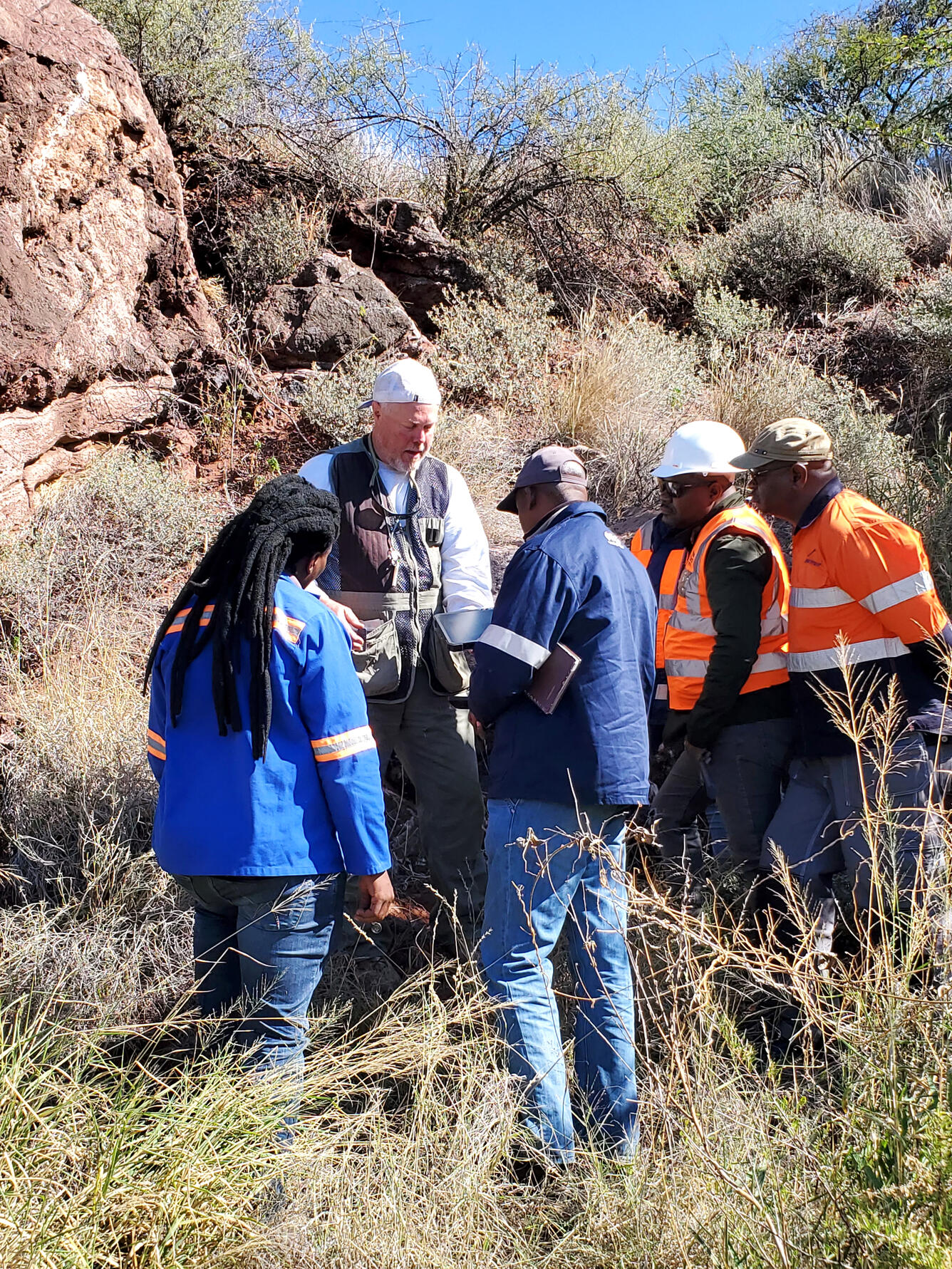 Dr. Cliff Taylor (retired USGS) in field with colleagues of the Botswana Geoscience