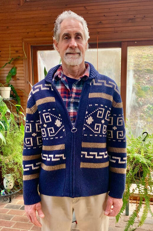 man wearing a bright sweater and shirt