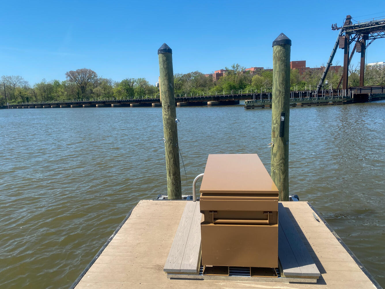 A gage box on a boat dock next to a river.