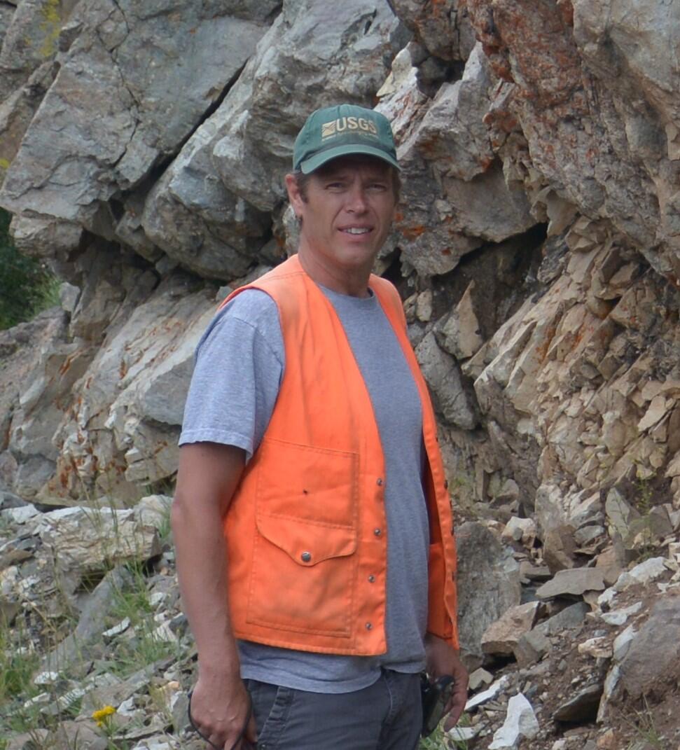 Eric Anderson standing near rock outcrop