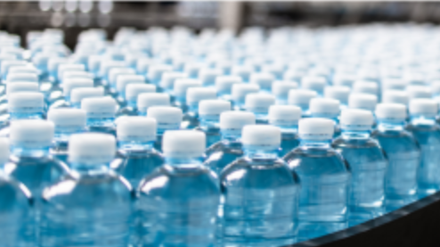 tops of bottles with blue water inside and white caps on top