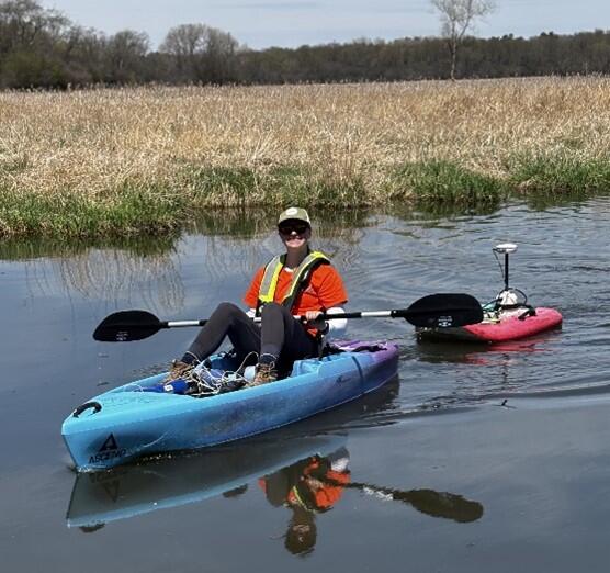 Izzy Seten collecting data in a kayak. 