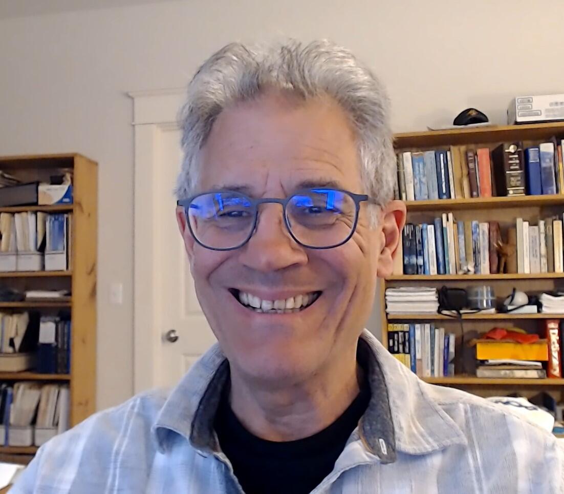 Image of ​Kenneth Belitz with a bookcase in the background