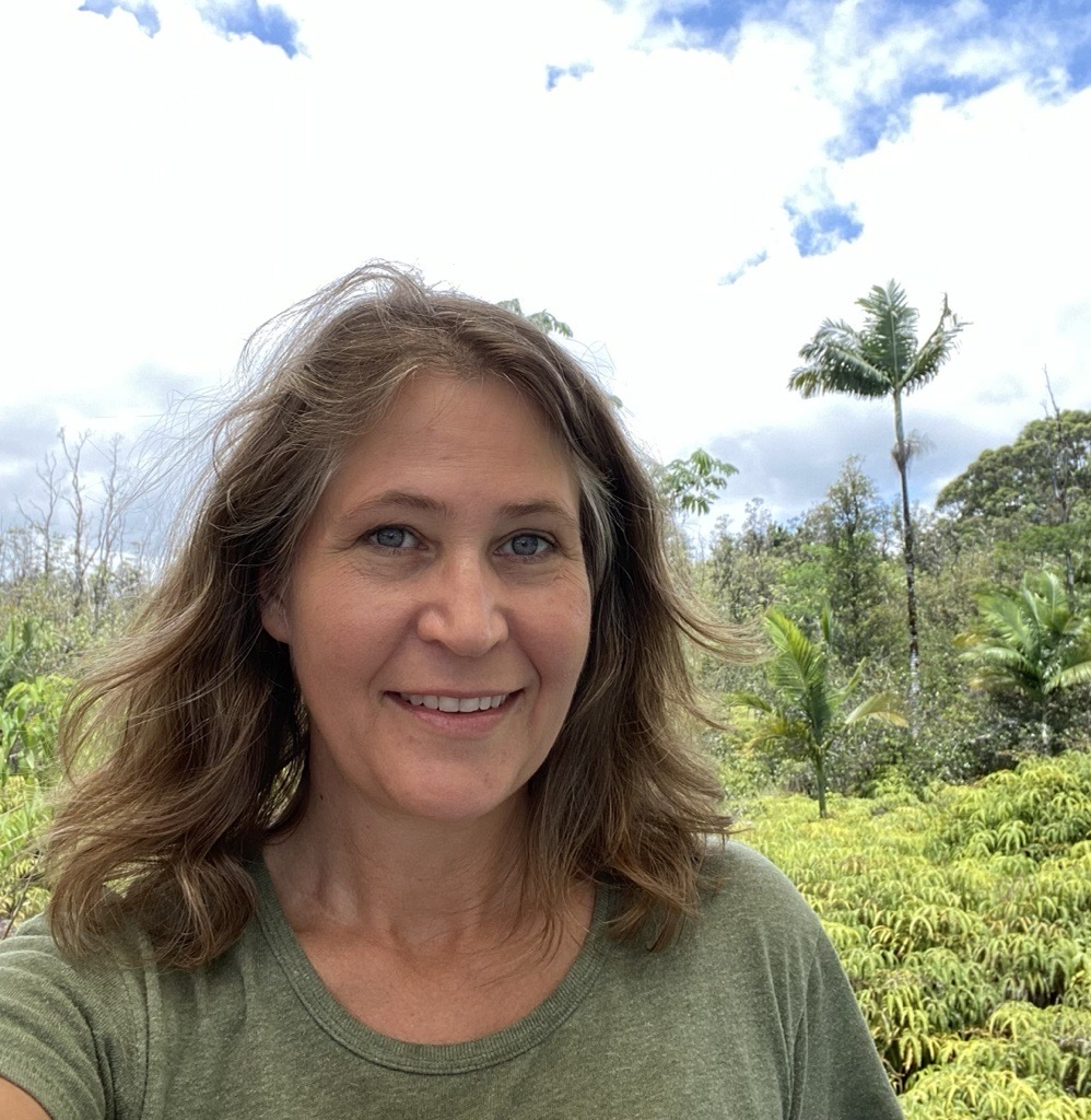 Picture of face with vegetation in background.