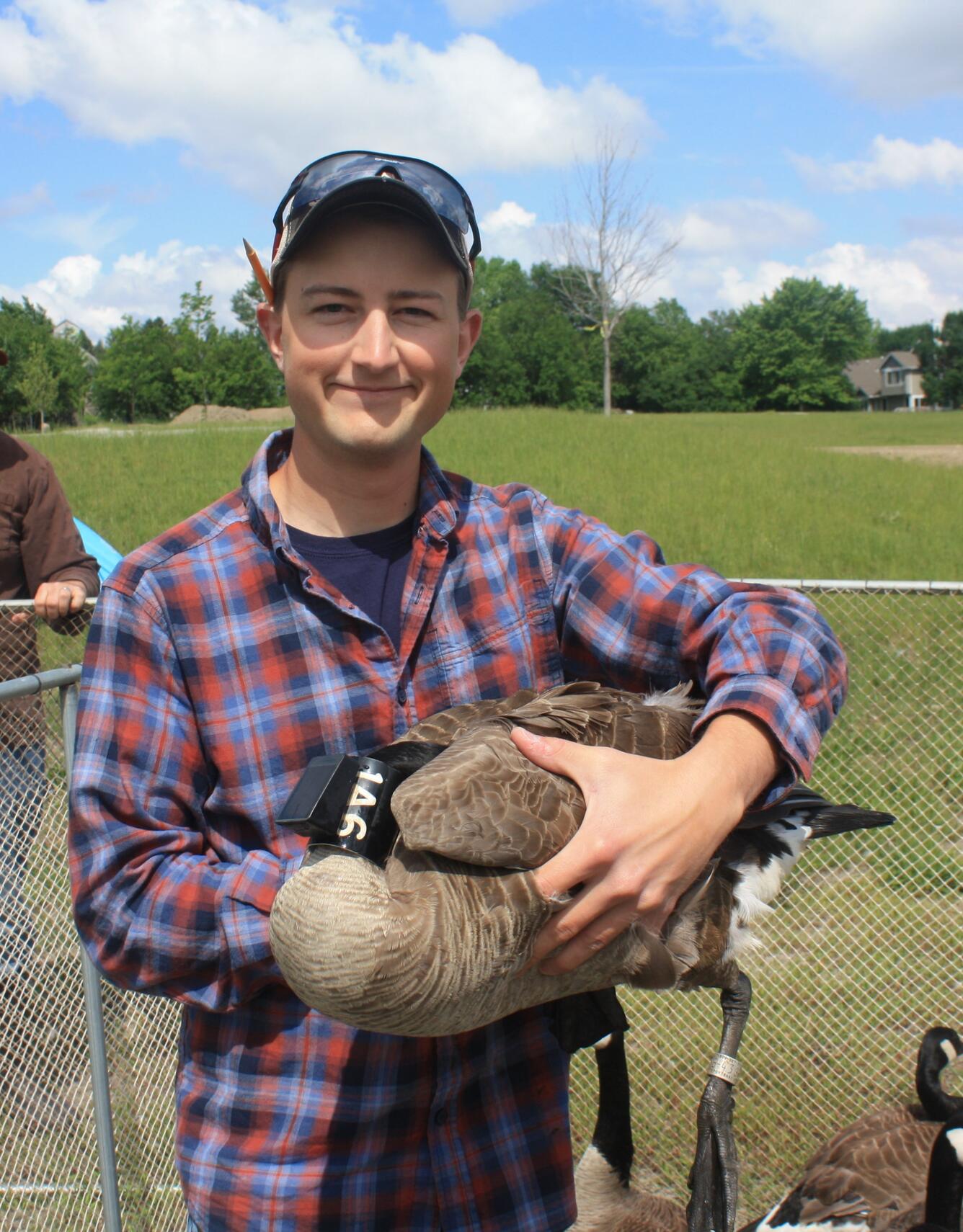 graduate student holding a canada goose