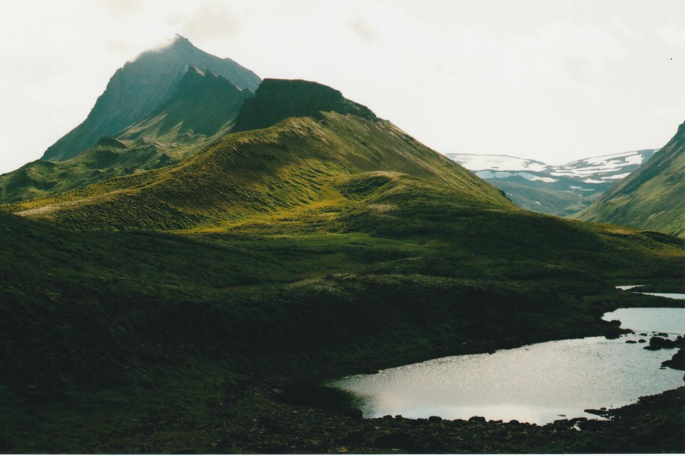 mountain peaks with lake in foreground