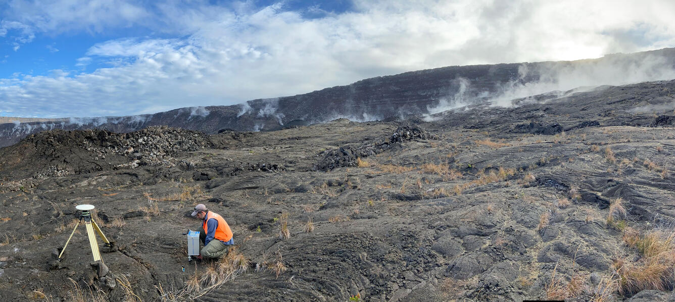 Color photograph of scientist deploying instrument in the field