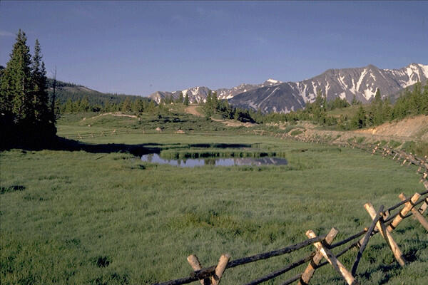 Photograph of Cache la Poudre Pass with mountains in the background 