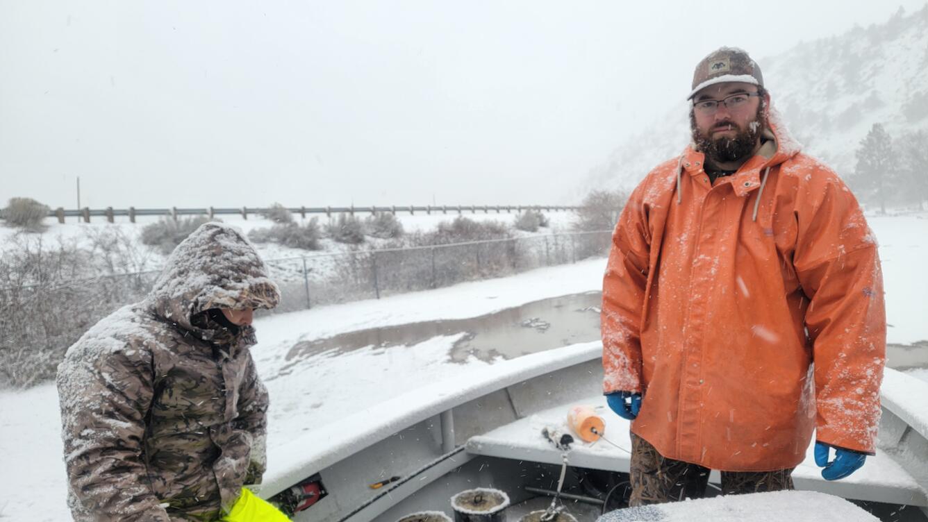 Two men in a boat in the snow on Upper Klamath Lake, Klamath Falls, OR