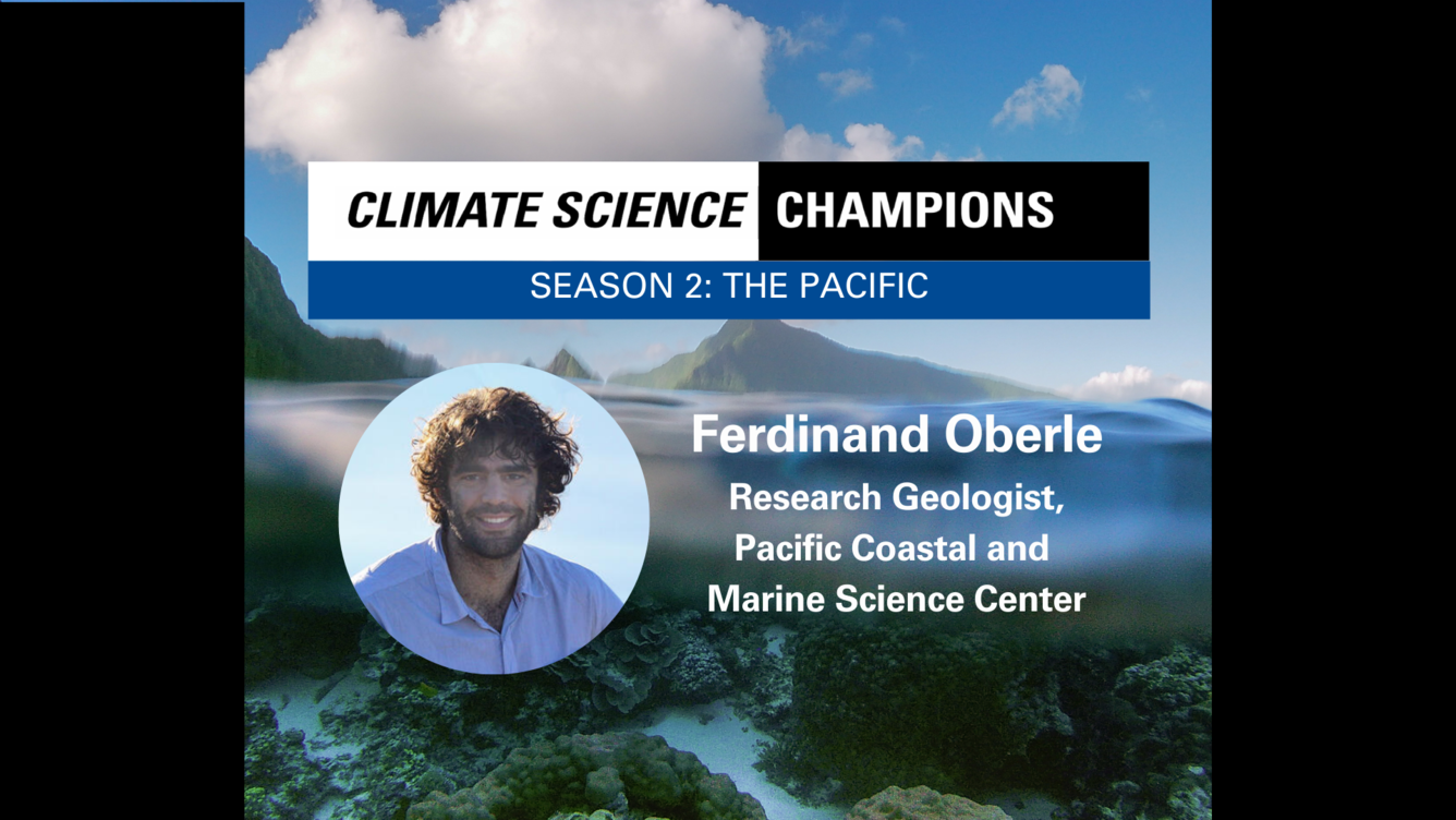 Background of coral reefs beneath waves. Overlaid with photo of smiling man with curly black hair and a black beard.