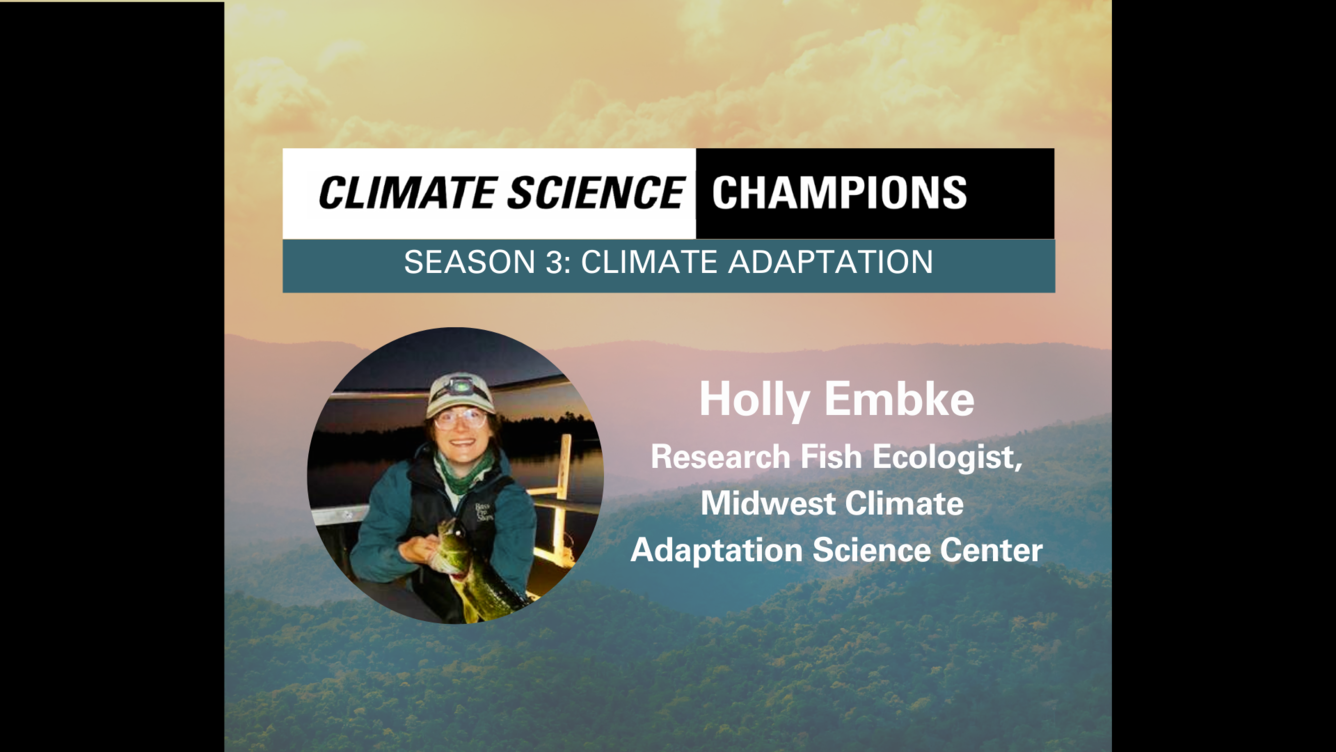 Misty Mountains, overlaid with a photo of a smiling white woman wearing waders and holding a fish.