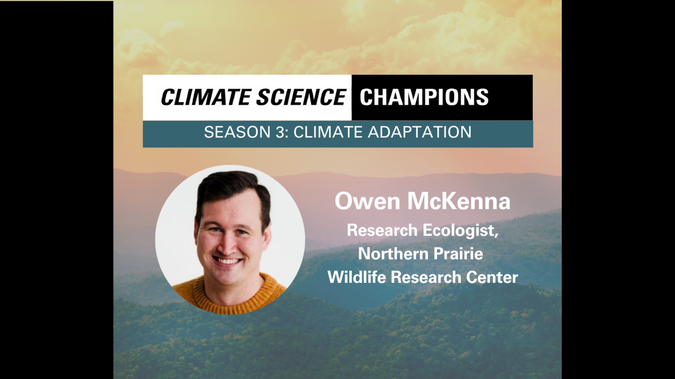 Misty mountains, overlaid with a headshot of a smiling white man with brown hair.