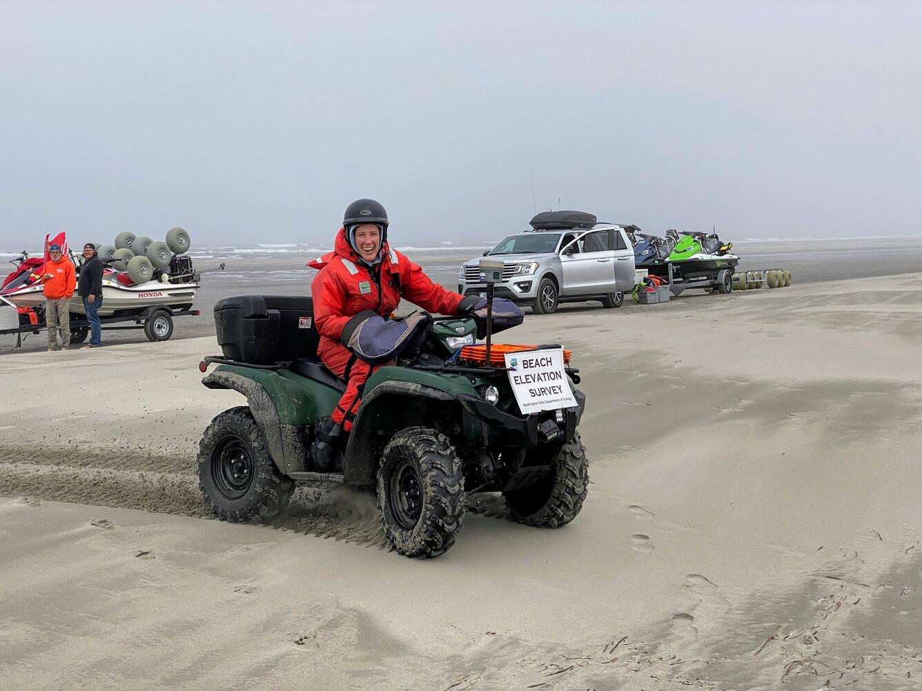 Diana McCandles collecting topographic data on an all-terrain vehicle