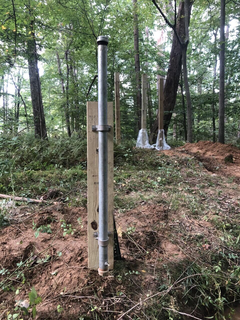 Crest stage gage, which resembles a capped pipe set into the streambank.